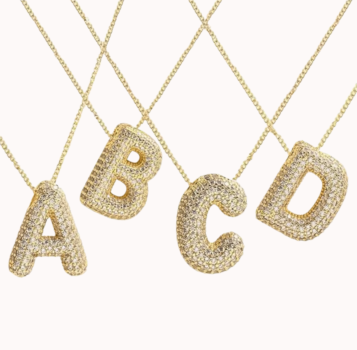 A set of four gold-plated initial necklaces with the letters 'ABCD', each encrusted with sparkling zirconia stones.