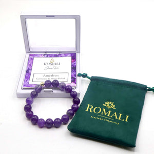 ROMALI 18K gold-plated natural amethyst beaded bracelet in packaging and pouch, promoting calmness and emotional balance.