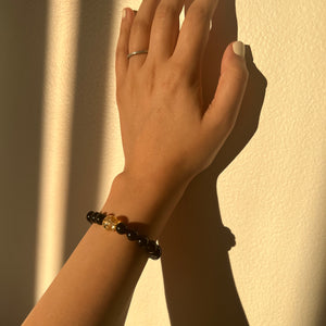 Hand with a ring and bracelet against a light background