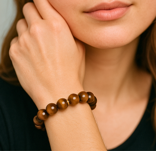 Close-up of a woman's hand wearing a wooden beaded bracelet.