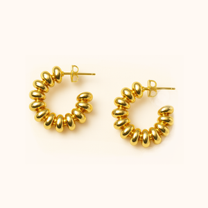 Gold hoop earrings on a white background