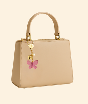 Beige handbag with a pink butterfly charm on a beige background