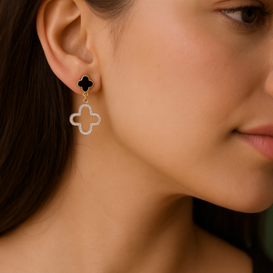 Close-up of a woman wearing a gold clover-shaped earring.