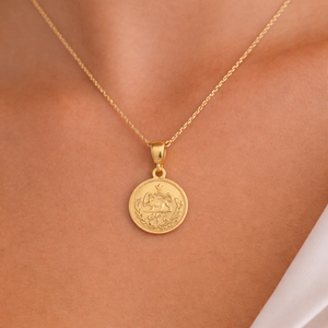 Iranian Gold necklace with a round pendant on a person's neck