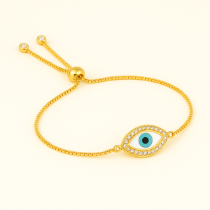 Gold bracelet with an eye design on a white background