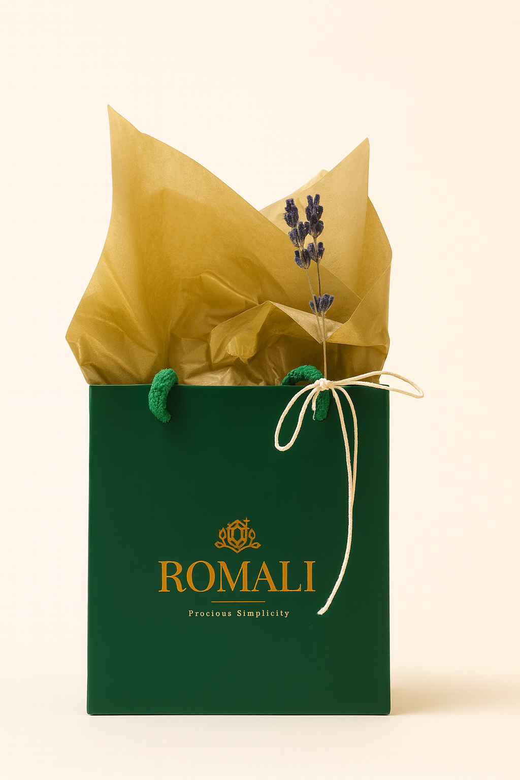 Green gift bag with gold interior and 'ROMALI' branding on a beige background