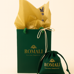 Green gift bag and pouch with yellow tissue paper featuring the Romali brand on a beige background.